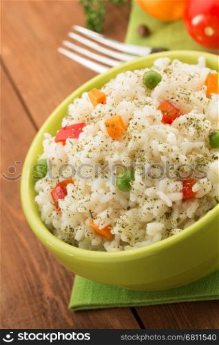 bowl full of rice isolated on wooden background