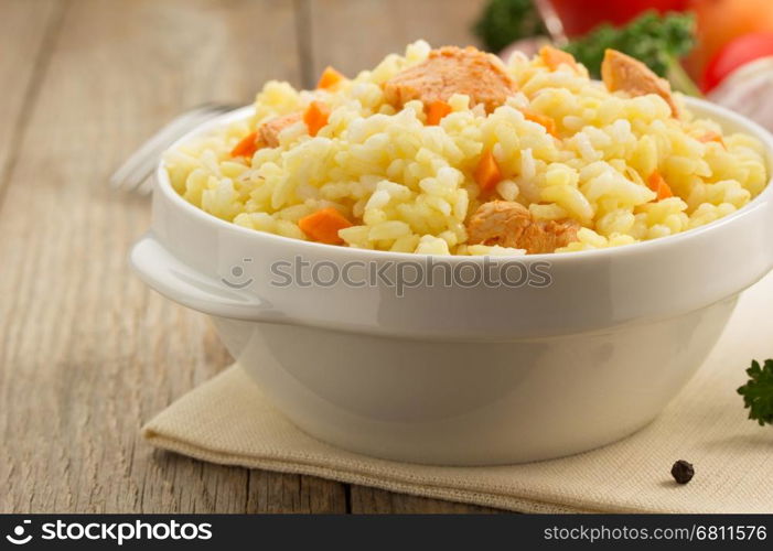 bowl full of rice on wooden background