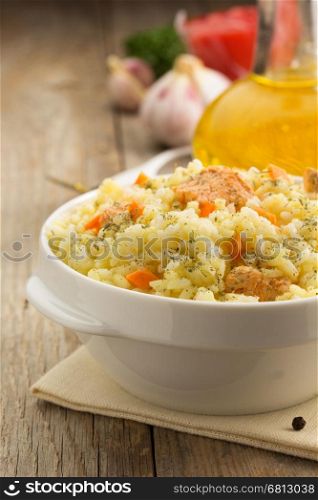 bowl full of rice on wooden background