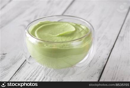 Bowl of avocado mayo on the wooden background