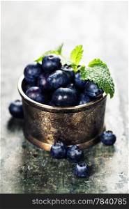 bowl of blueberries on wooden background