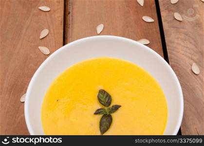 Bowl of Butternut Squash Soup on Old Wooden Table