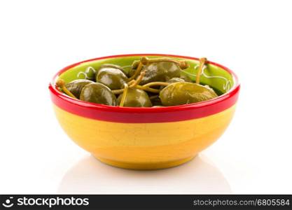 Bowl of canned capers on a white background