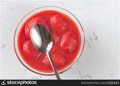 Bowl of canned tomatoes on the table