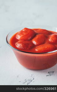 Bowl of canned tomatoes on the table