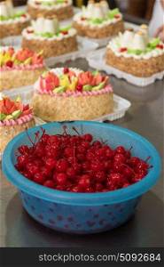 Bowl of cherry on cake production. Bowl of cherry on cake production in factory