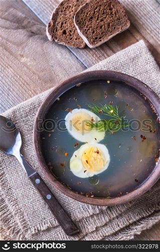 Bowl of chicken stock on the wooden table