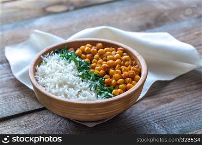 Bowl of chickpea curry with white rice and fresh cilantro