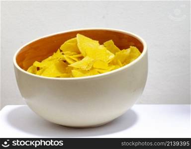 bowl of chifles (fried plantain) on a white background