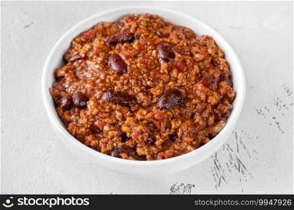 Bowl of chili con carne on white background