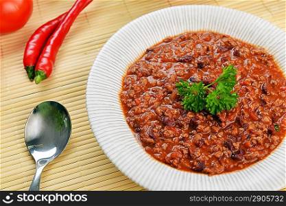 Bowl of chili with peppers and beans