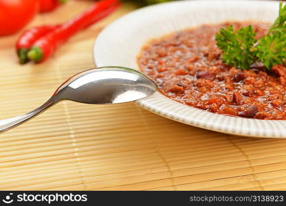 Bowl of chili with peppers and beans