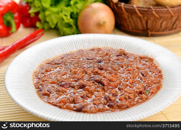 Bowl of chili with peppers and beans