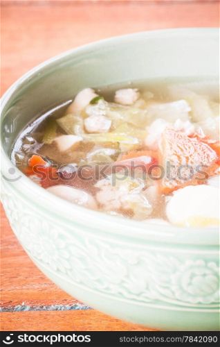 Bowl of clear soup with minced pork and vegetable