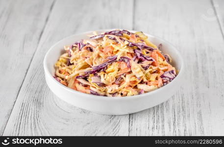Bowl of Coleslaw salad on wooden table