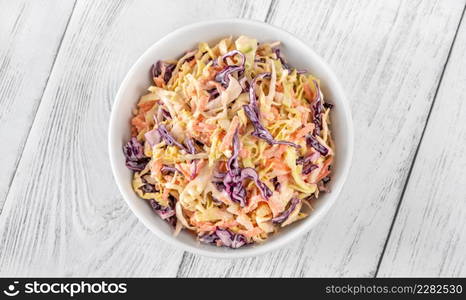 Bowl of Coleslaw salad on wooden table