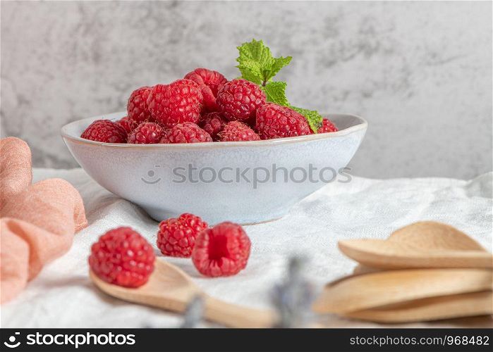 Bowl of delicious fresh ripe raspberries, closeup view