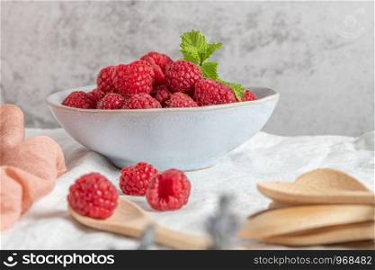 Bowl of delicious fresh ripe raspberries, closeup view