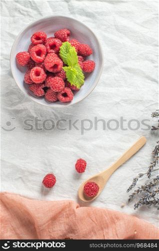 Bowl of delicious fresh ripe raspberries, closeup view. Top view