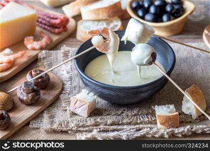 Bowl of fondue with appetizers