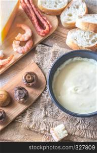 Bowl of fondue with appetizers