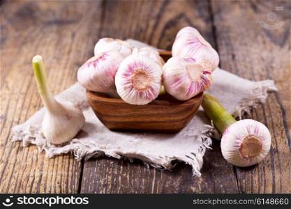 bowl of fresh garlic on a wooden table