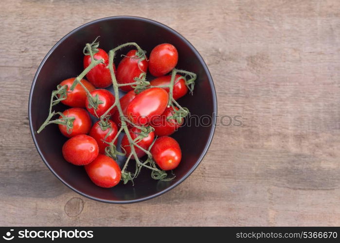 Bowl of fresh Perino tomatoes in rustic setting