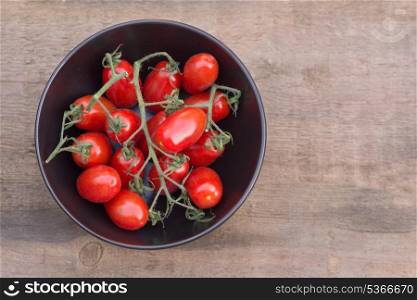 Bowl of fresh Perino tomatoes in rustic setting