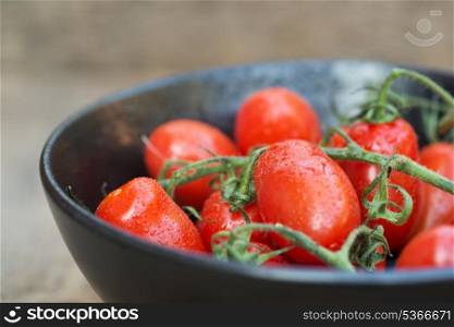 Bowl of fresh Perino tomatoes in rustic setting