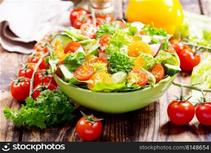 bowl of fresh salad on wooden table