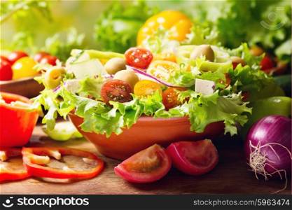 bowl of fresh vegetable salad on wooden table