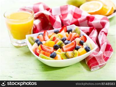 bowl of fruit salad on wooden table
