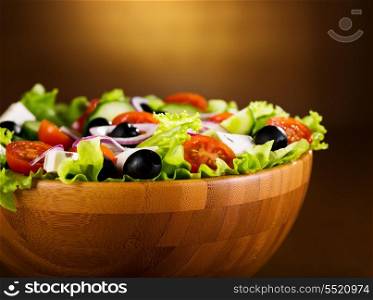 bowl of greek salad on wooden table