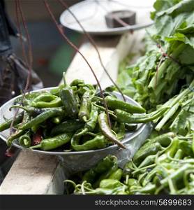 Bowl of green chili peppers at the vegetable market in Thimphu, Bhutan