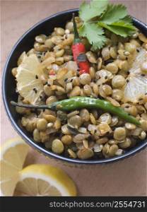 Bowl of Green Lentils cooked with Sliced Lemon Chili and Coriander