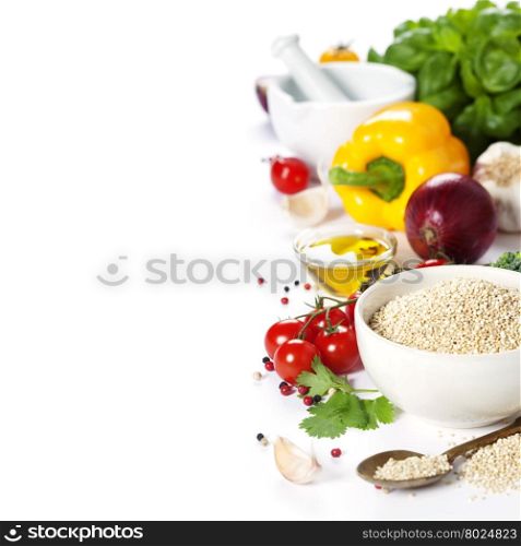Bowl of healthy white quinoa seeds with vegetables over white