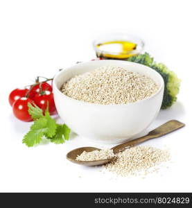 Bowl of healthy white quinoa seeds with vegetables over white