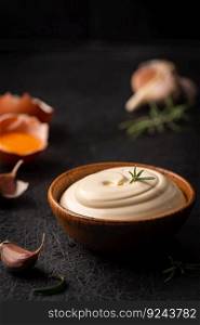 Bowl of Homemade mayonnaise sauce with ingredients and herbs for cooking. Homemade mayonnaise sauce