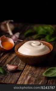 Bowl of Homemade mayonnaise sauce with ingredients and herbs for cooking. Homemade mayonnaise sauce