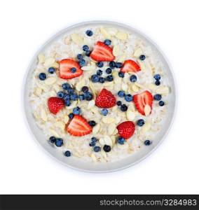 Bowl of hot oatmeal breakfast cereal with fresh berries from above