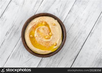 Bowl of hummus garnished with olive oil and paprika