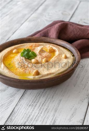 Bowl of hummus garnished with olive oil and paprika