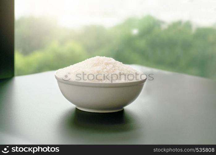 bowl of jasmin white rice on yellow backgrounds