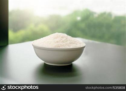 bowl of jasmin white rice on yellow backgrounds