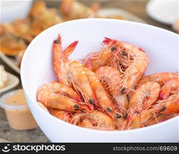Bowl of large fresh shrimp with other seafood behind