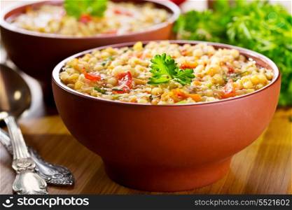 bowl of lentil soup on wooden table