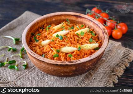 Bowl of Mexican rice on the wooden table