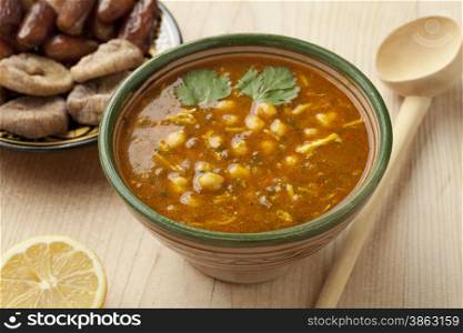 Bowl of Moroccan harira soup, lemon, dates and figs for iftar