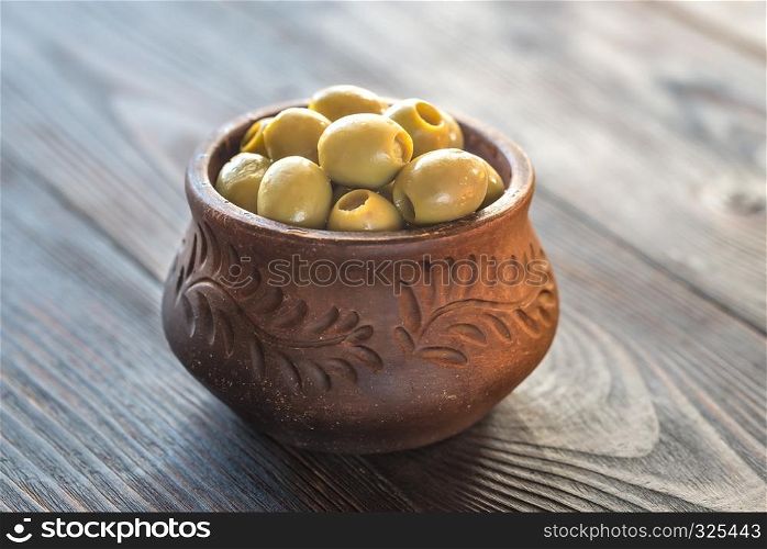 Bowl of olives on the wooden table