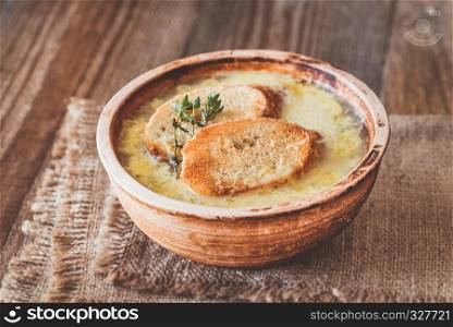 Bowl of onion soup on the wooden table